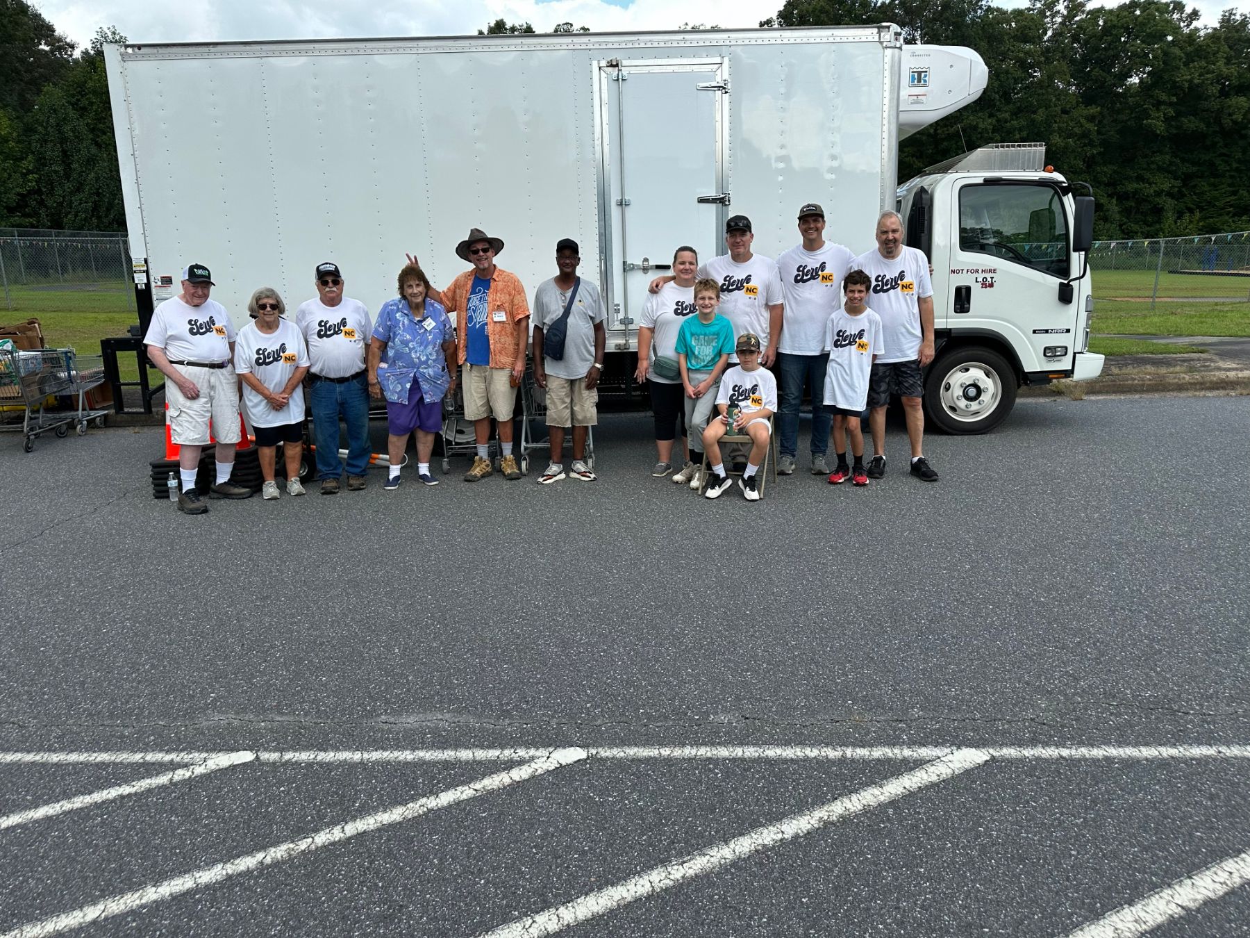 A team in ServeNC shirts stocking shelves at a community food pantry